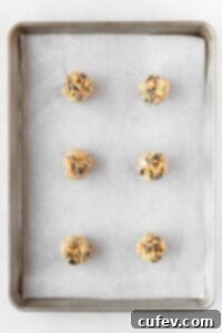 Balls of cookie dough on a baking sheet.