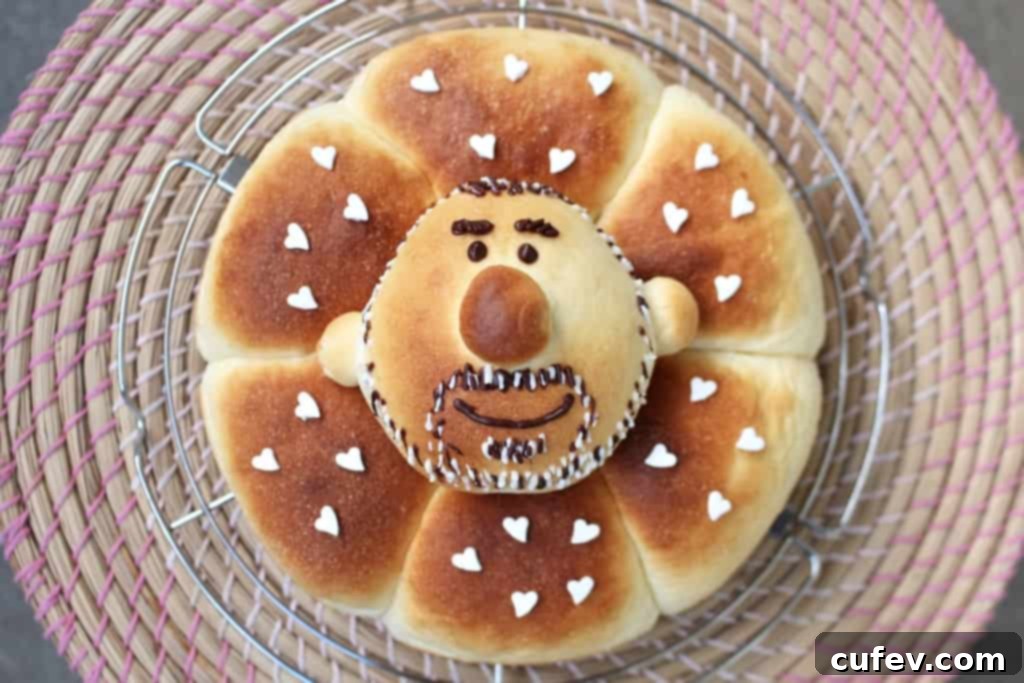 Freshly baked blueberry cream cheese buns with a custom-decorated bun featuring a bearded man's face for a birthday celebration.