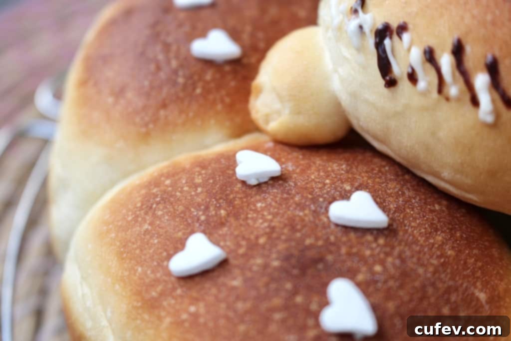 Assembling the decorated 'dad' bun on top of the ring of blueberry cream cheese buns, adding heart sprinkles.