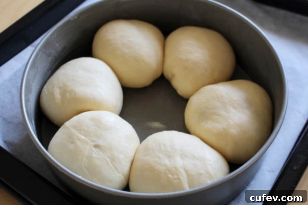 Instructions on filling and shaping blueberry cream cheese buns, emphasizing the importance of pinching the dough shut.