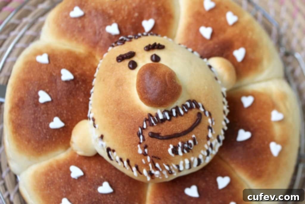 Decorating the custom blueberry cream cheese bun with melted dark chocolate for facial features.