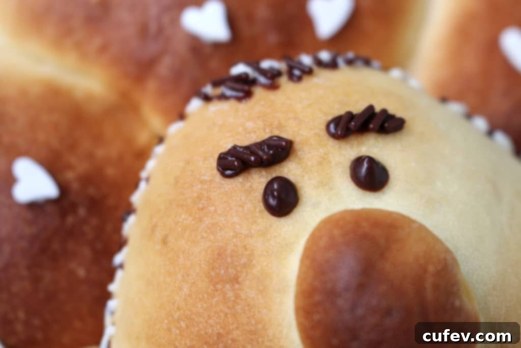 Adding chocolate jimmies to the decorated bun for extra beard texture.