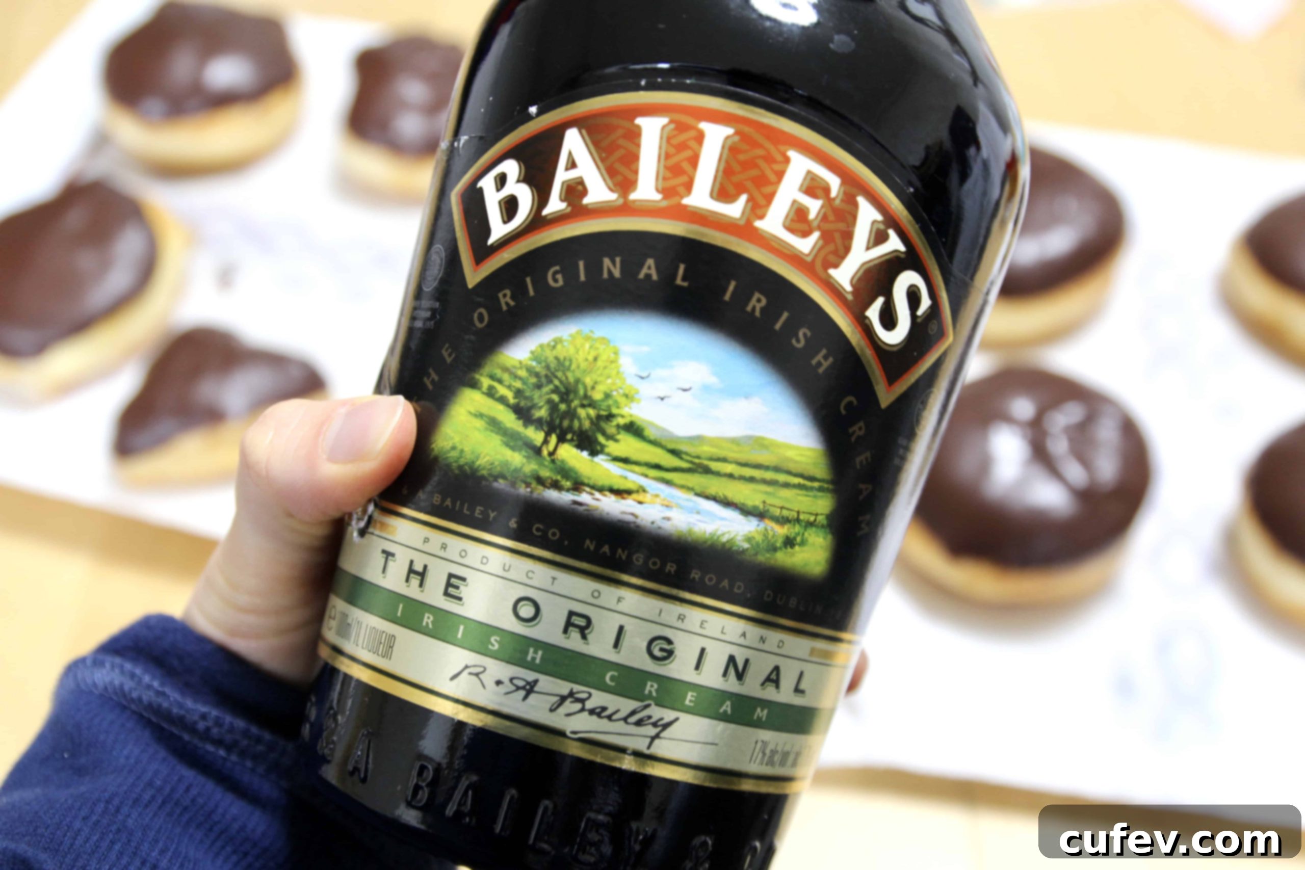 A bottle of Baileys Irish Cream, highlighted as the key ingredient for infusing the Baileys Boston Cream Doughnuts with unique flavor.