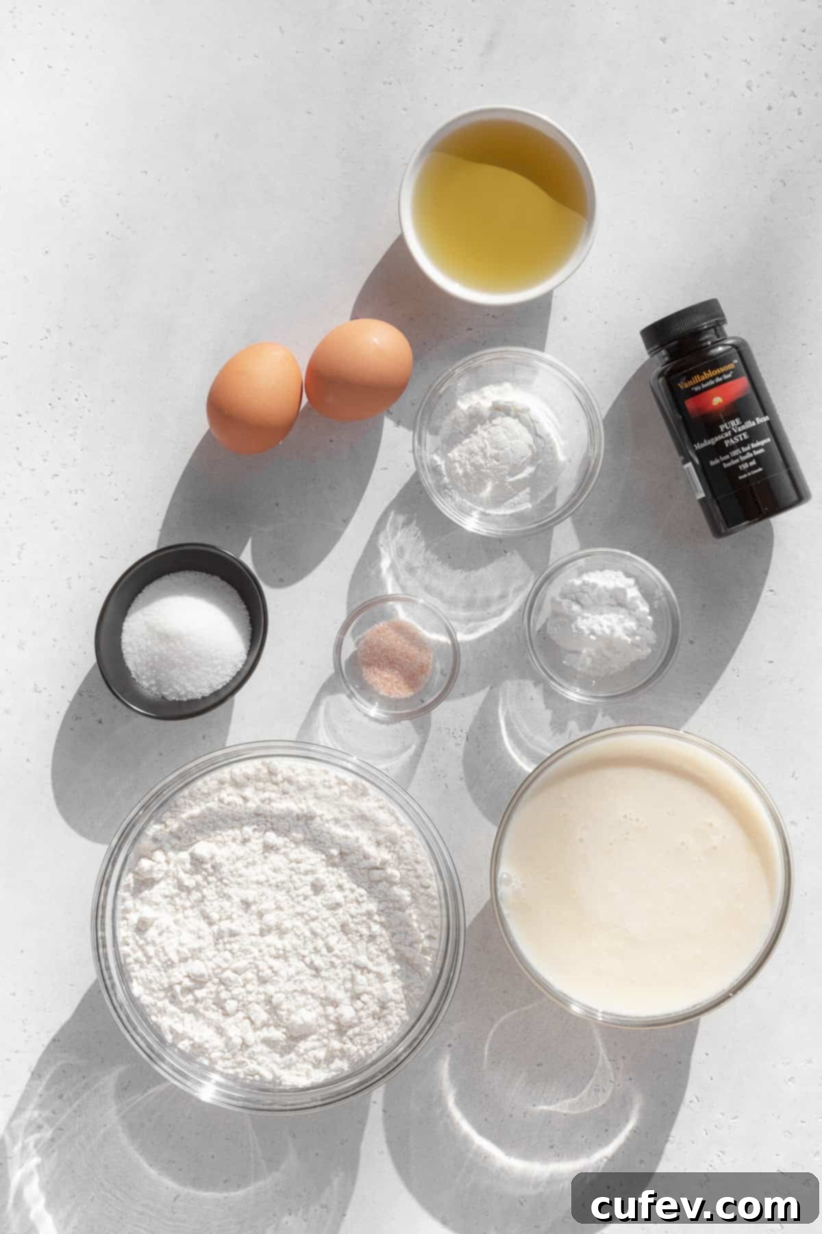 A curated display of ingredients for gluten-free waffles, meticulously measured out into individual bowls, showcasing the preparation for a perfect batch.