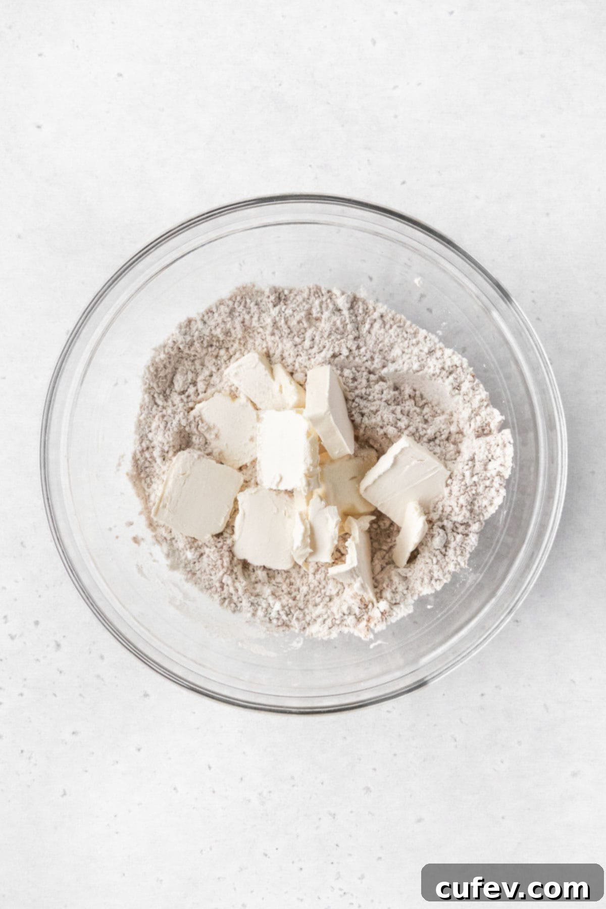 Squares of butter and dry ingredients for making coffee cake topping.