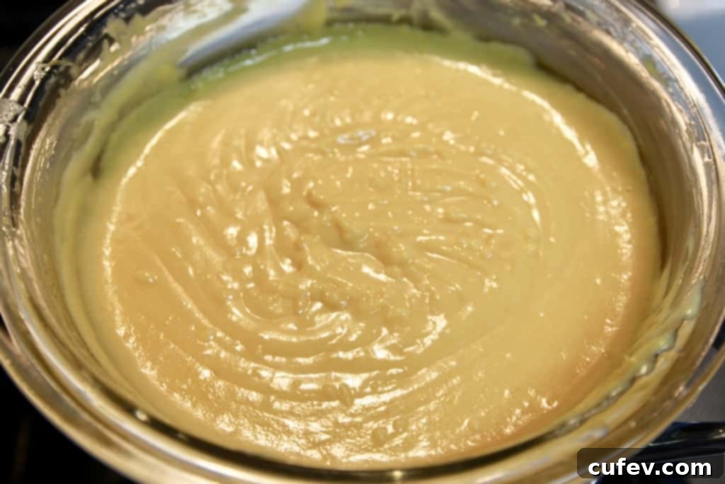Close-up of fresh grapefruit zest being finely grated and juice being squeezed for the vibrant curd.