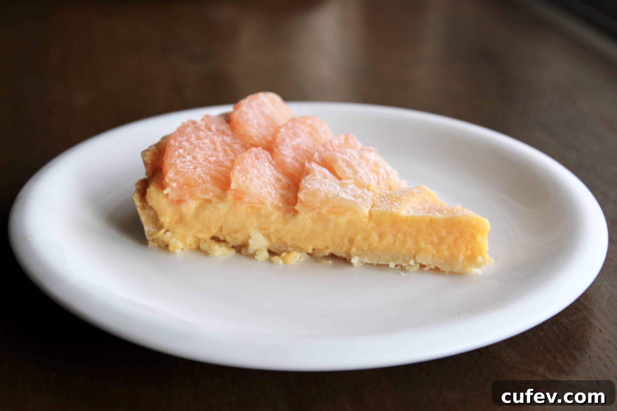 Grapefruit curd tart with fresh grapefruit segments.