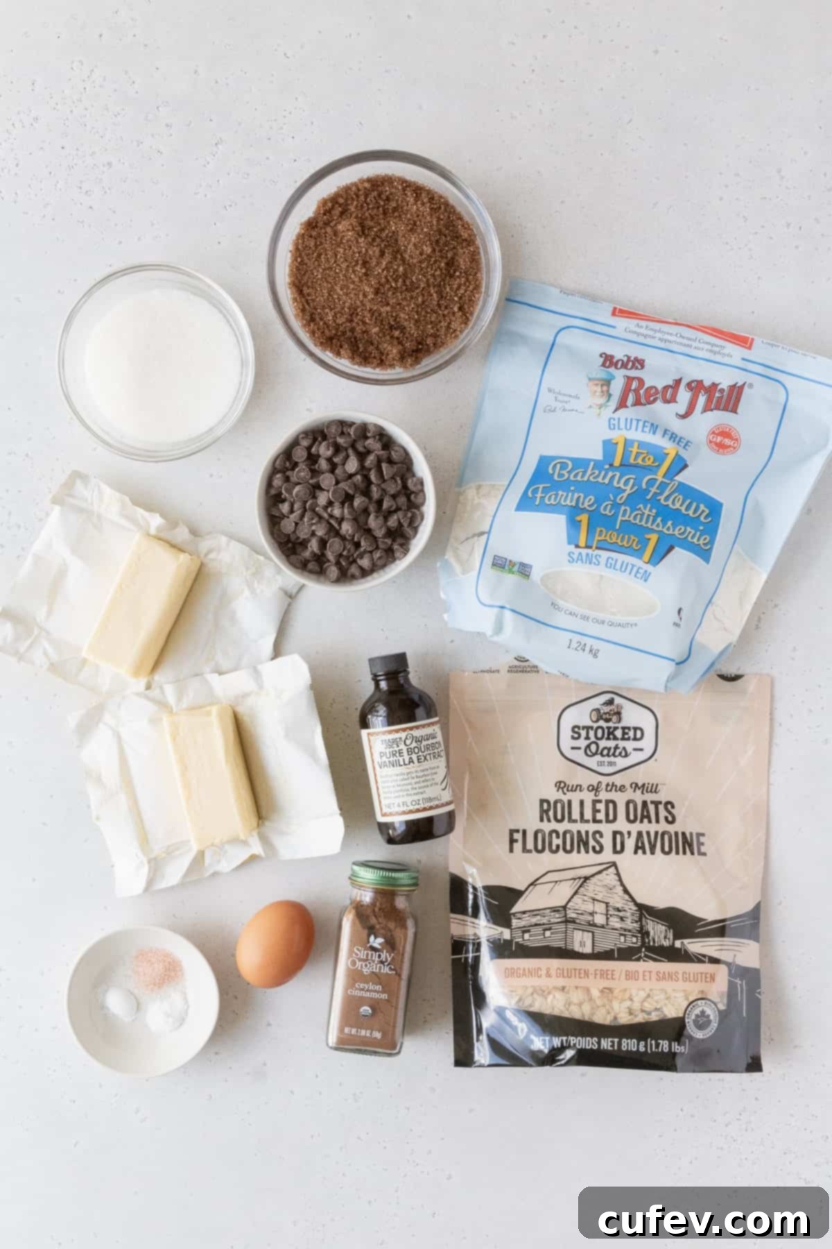 Ingredients to make gluten free oatmeal cookies laid out on a grey surface.