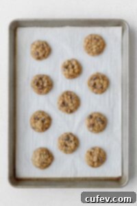 Baked oatmeal cookies on a baking sheet.