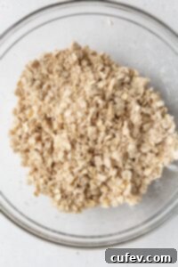 Comforting Gluten-Free Apple Crumble 7 Streusel topping in a glass bowl.