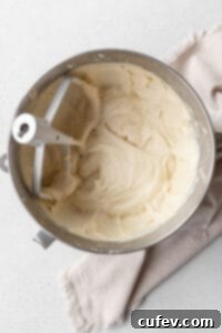 Muffin batter in the bowl of a stand mixer.