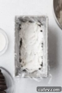 Velvet Chill Cake 6 A smooth, even layer of rich, white cream cheese filling spread across the cookies in a loaf pan, forming the next delicious tier of the icebox cake.