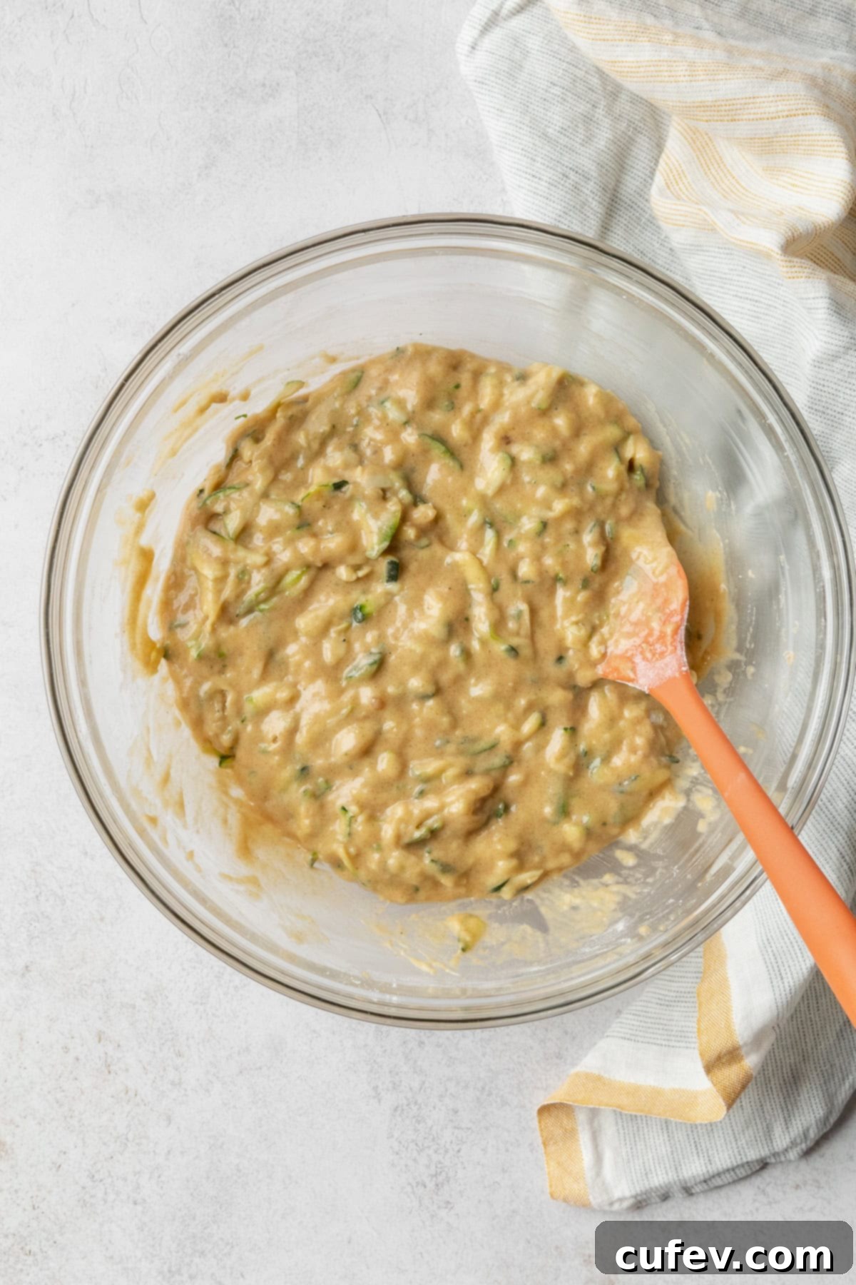 Zucchini bread batter in a glass bowl.