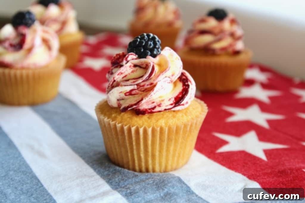 These fresh corn cupcakes are bursting with summer flavor! Featuring fluffy, moist cupcakes infused with real corn, topped with silky buttercream frosting that combines sweet corn and tart, fruity blackberries in a beautiful swirl. It’s the perfect, unique dessert for your Fourth of July BBQ or any summer celebration. #corncupcakes #freshcorn #blackberryfrosting #summerdessert #fourthofjuly #bbqdessert #homemaderecipe #moistcupcakes #sweetcorn #berrydessert
