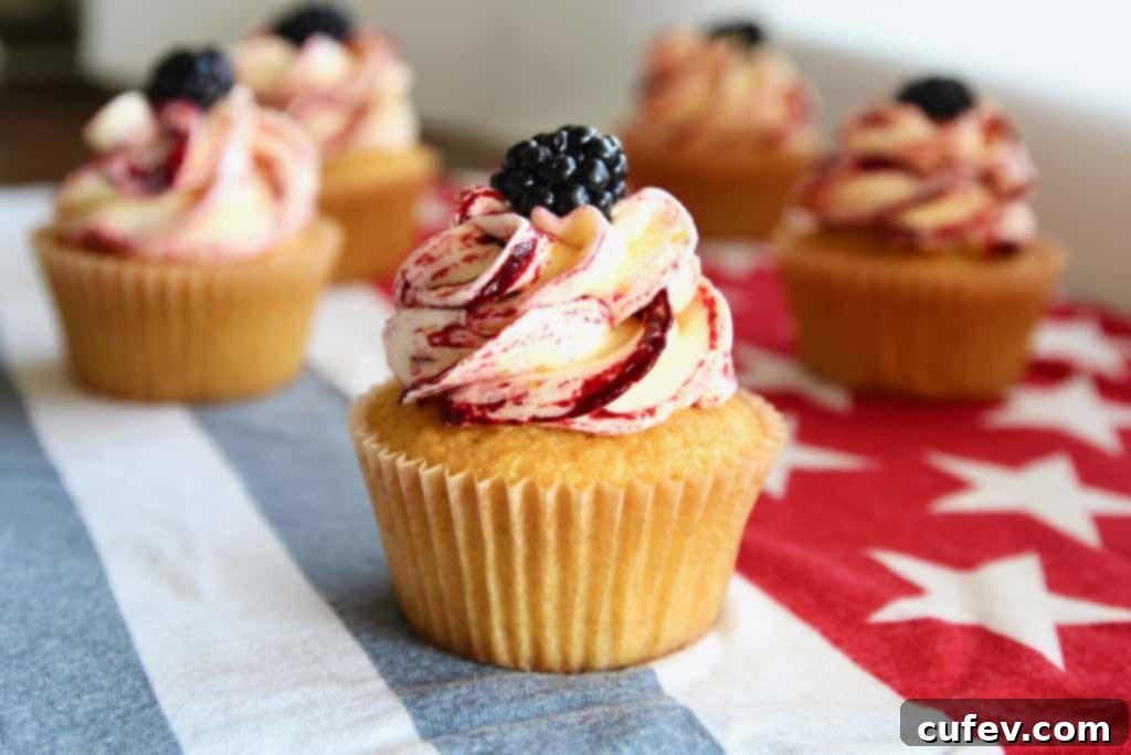 These corn cupcakes are truly special, featuring fresh corn in both the moist cupcake base and the silky buttercream frosting, beautifully swirled with tart blackberries. An irresistible dessert perfect for any summer gathering, especially a Fourth of July BBQ! #corncupcakes #blackberryfrosting #summerdesserts #4thofjulyfood #homemadecupcakes #uniquebaking #freshingredients #dessertgoals #bbqparty