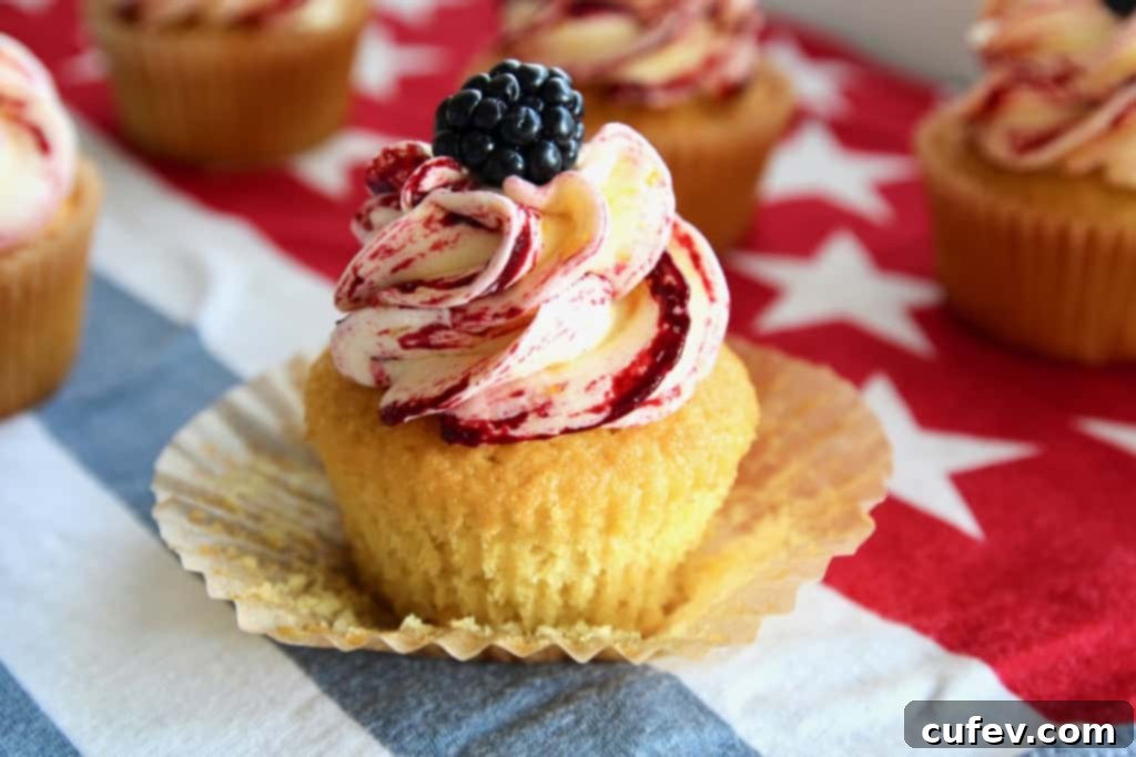 These corn cupcakes are truly unique, packed with fresh corn flavor in both the fluffy cake and the creamy frosting, beautifully accented with a tart blackberry swirl. They are the ultimate festive dessert for your Fourth of July BBQ! #freshcorncupcakes #blackberryswirl #fourthofjulycupcakes #summerbaking #moistdessert #sweetandsour #bbqdessertideas #homemadetreats