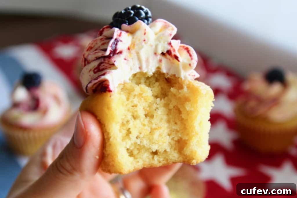 Super fluffy and moist corn cupcakes generously topped with creamy corn buttercream frosting and a fresh blackberry. A perfect summer treat!