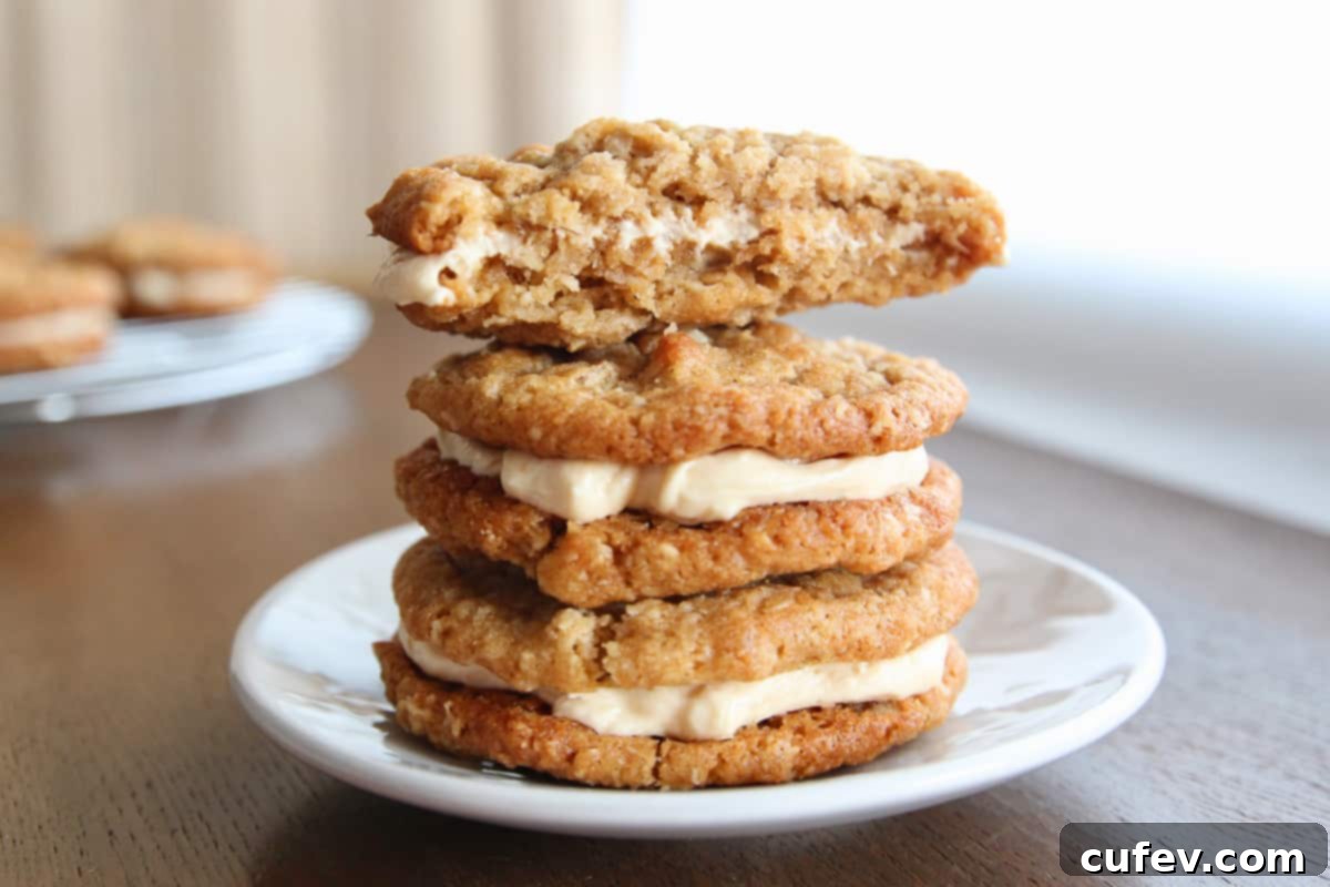 A stack of oatmeal cream pies with a bitten oatmeal cookie sandwich on top.