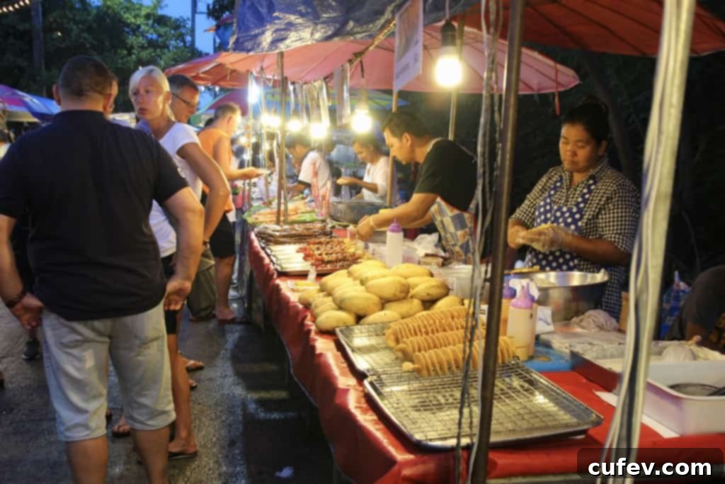Vibrant and crowded night market at Fisherman's Village with food and souvenir stalls