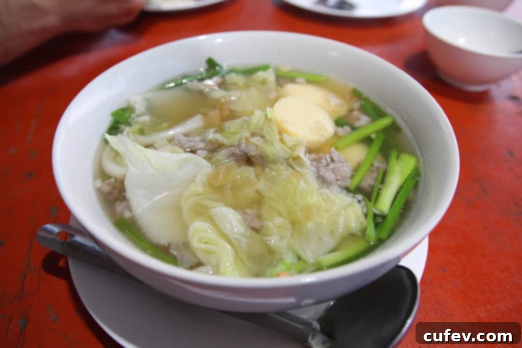 A pregnant woman struggling with morning sickness amidst beautiful Koh Samui scenery