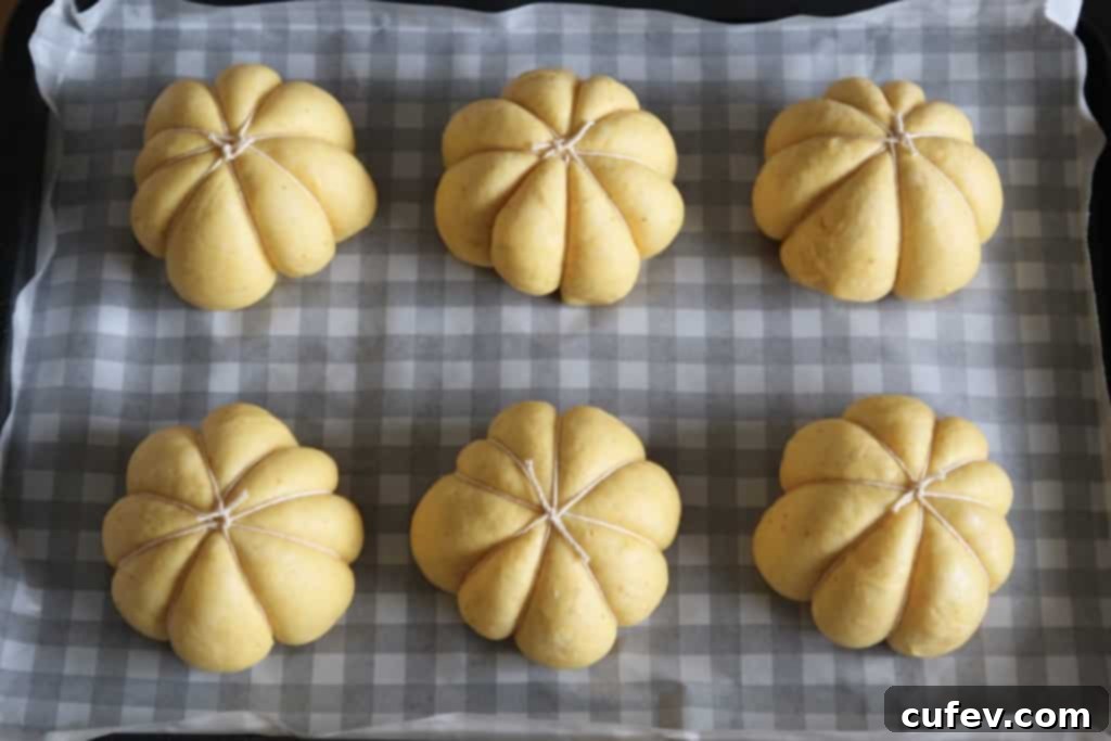Close-up of perfectly baked pumpkin buns, showcasing their realistic pumpkin shape and golden-orange color.