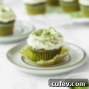 Matcha cupcake with white chocolate frosting on a plate