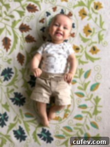 Hugo, a baby boy playing on a mat