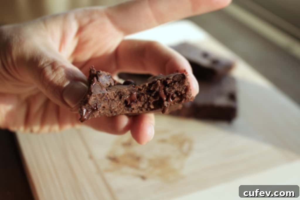Stack of Peppermint Black Bean Brownies with a dusting of cacao powder