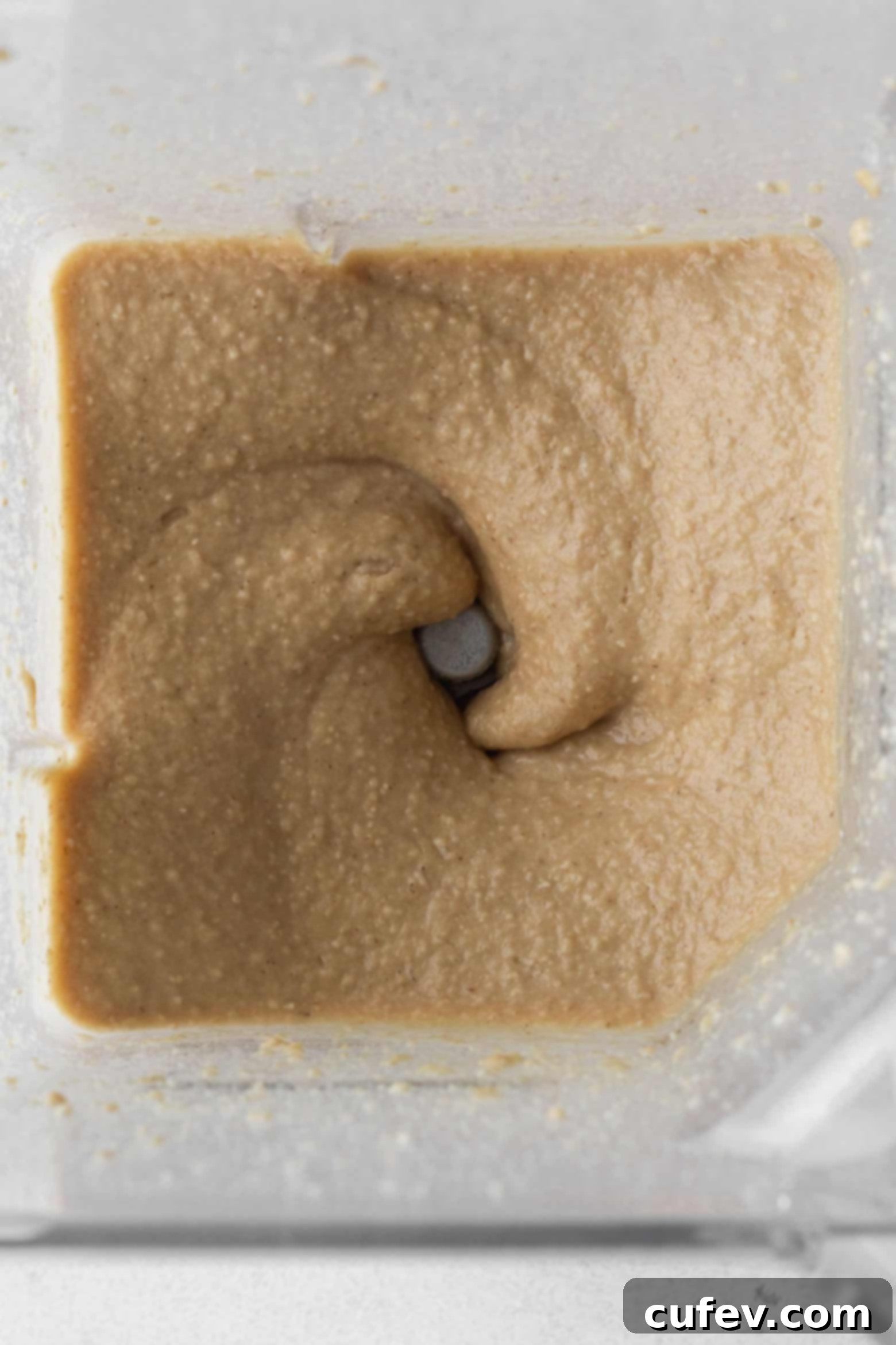 Smooth chickpea cookie dough forming in the blender after processing.