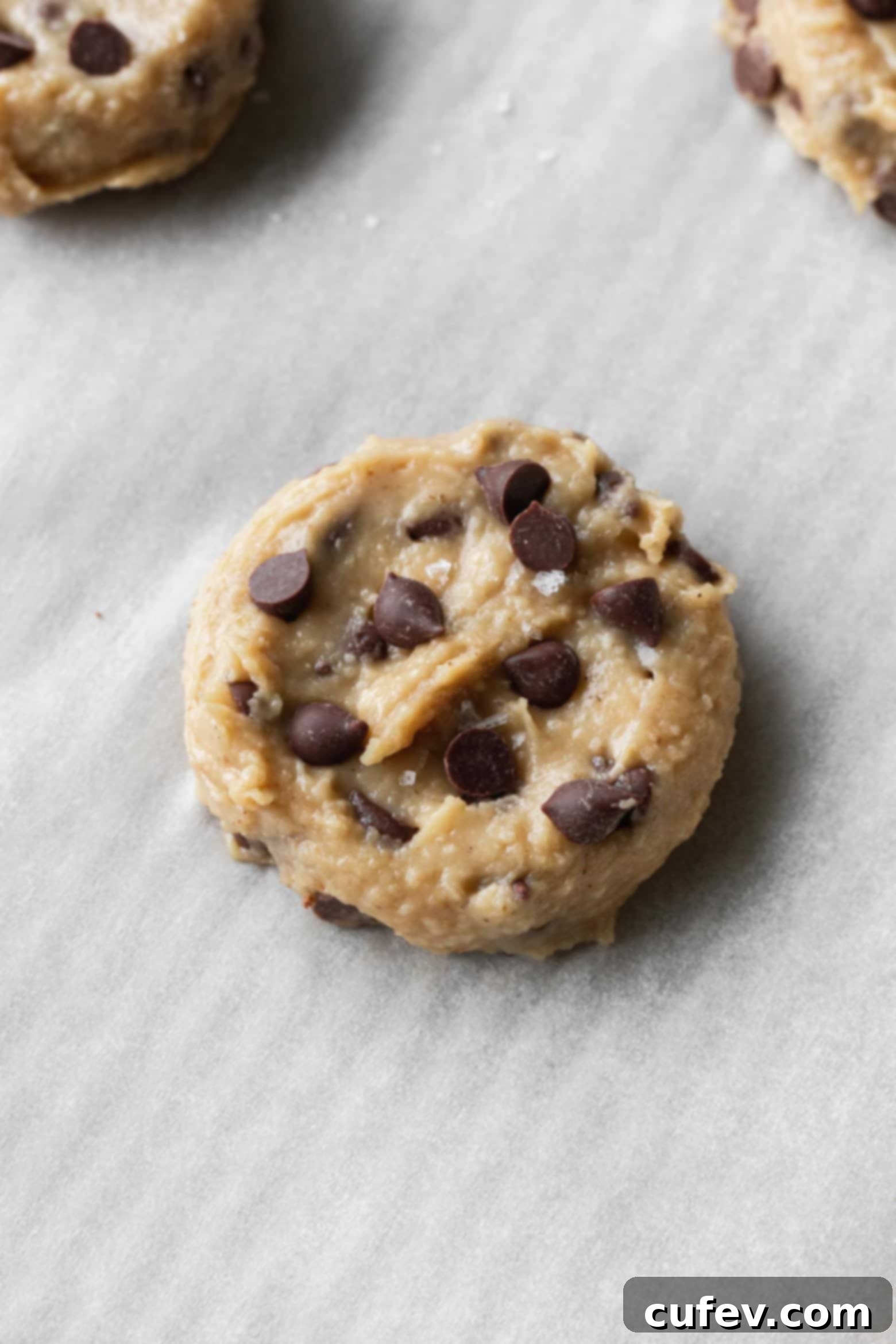 Chickpea cookie dough with added chocolate chips and a sprinkle of flaky sea salt before baking.