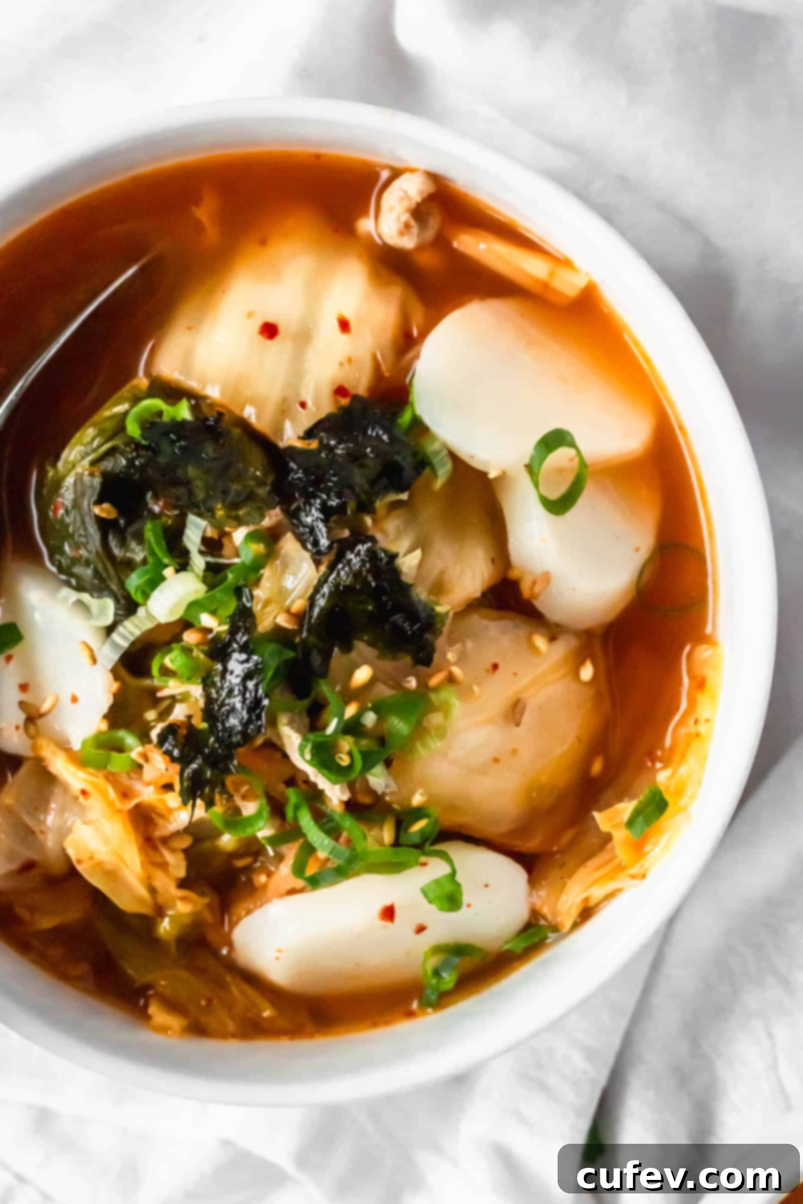Kimchi Tteokguk A Zesty Korean Comfort Bowl 5 Spicy and delicious Kimchi Tteokguk (Korean rice cake soup) with probiotics, a healthy and easy Korean comfort food meal. #kimchisoup #probiotics #spicysoup #Koreanfood #healthymeals