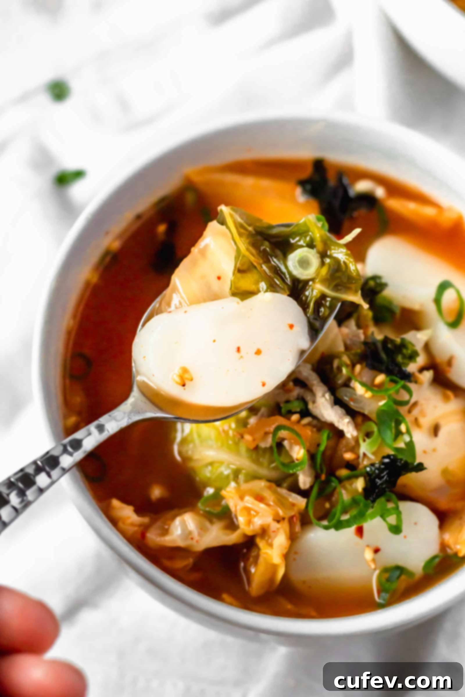 Kimchi Tteokguk A Zesty Korean Comfort Bowl 6 Delicious and healthy Kimchi Tteokguk (Korean rice cake soup) with chewy tteok, rich in probiotics for a healthy gut. #kimchisoup #probiotics #spicysoup #Koreanfood #healthymeals