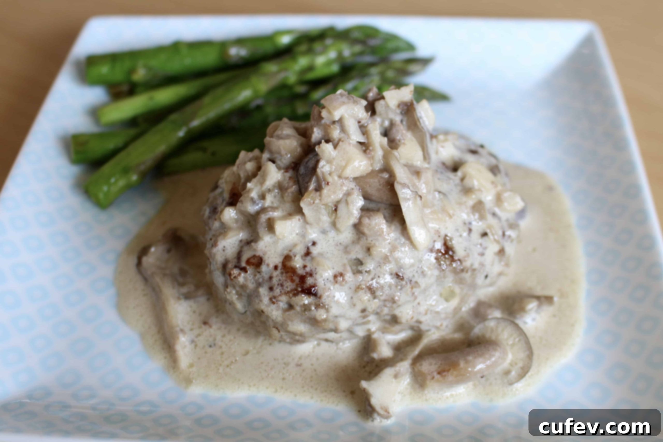 Savory Salisbury Steak with creamy mushroom sauce and fresh parsley garnish, served on a white plate