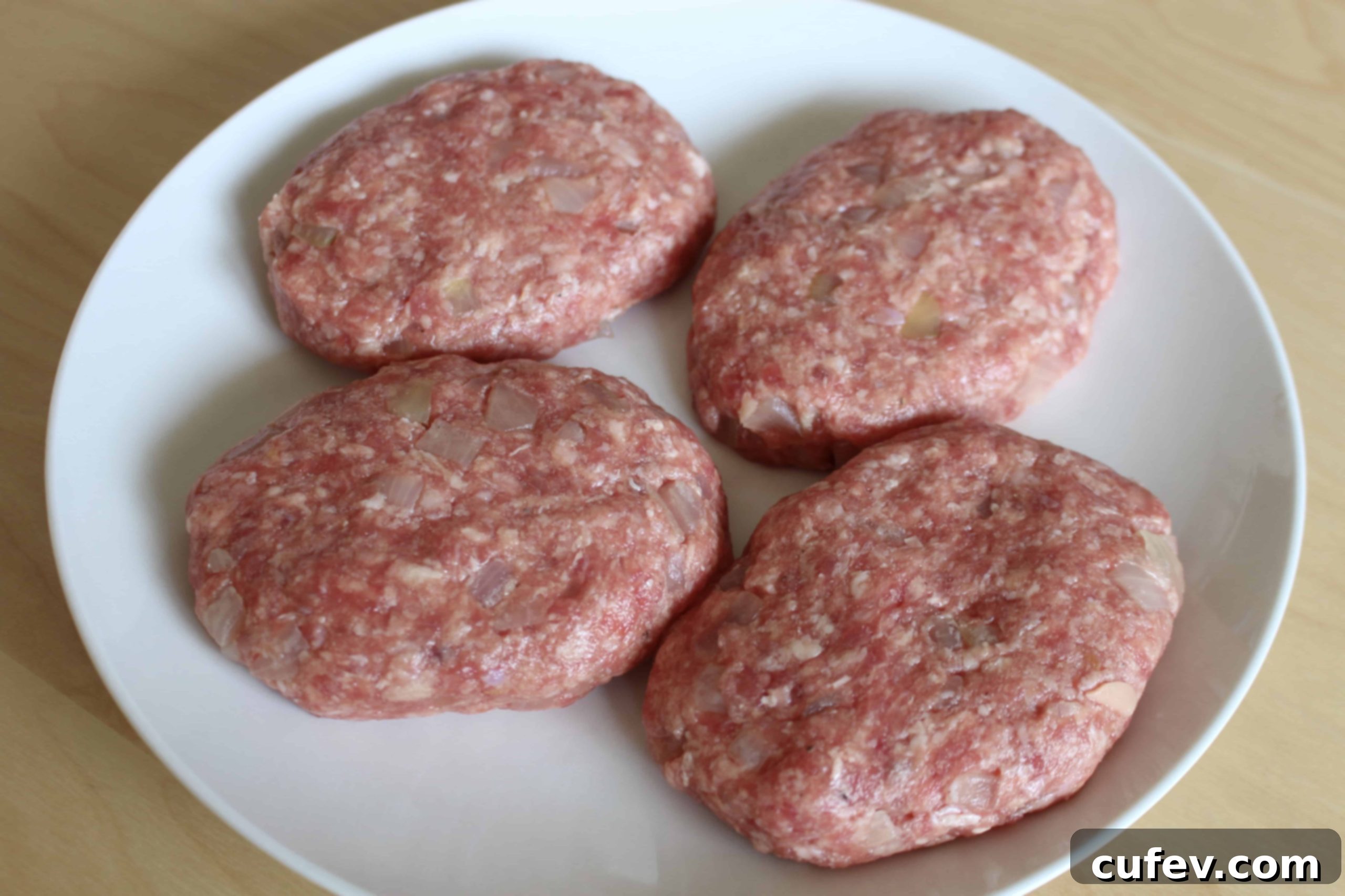 Mixing ground pork, breadcrumbs, onion, egg, and seasonings for Salisbury steak patties