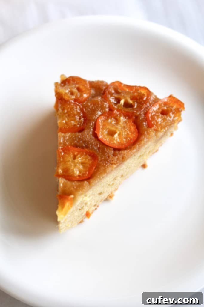 A slice of Kumquat Upside Down Cake with visible sliced almonds