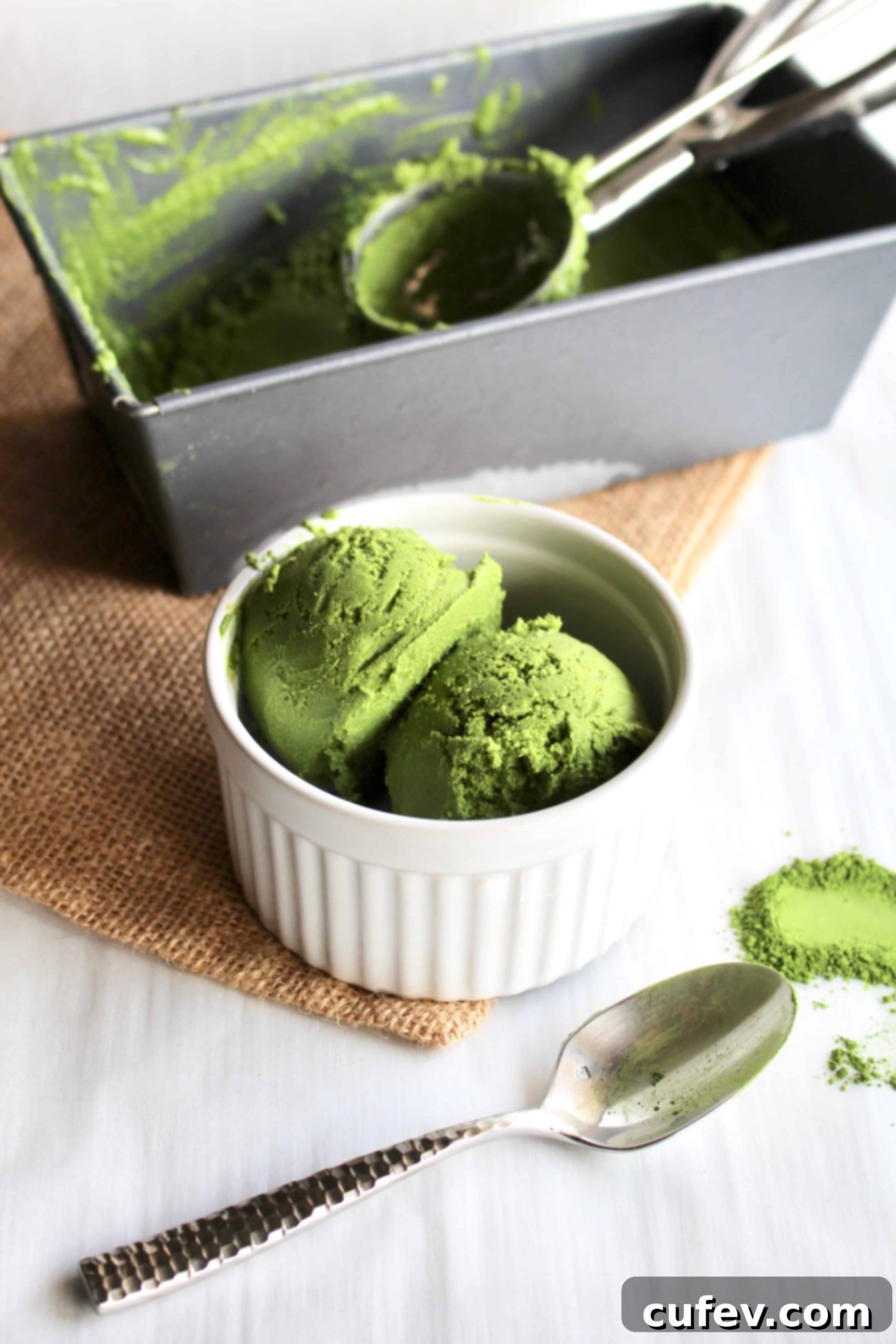 A scoop of homemade vegan matcha ice cream in a small white ramekin, showcasing its vibrant green color and creamy texture.