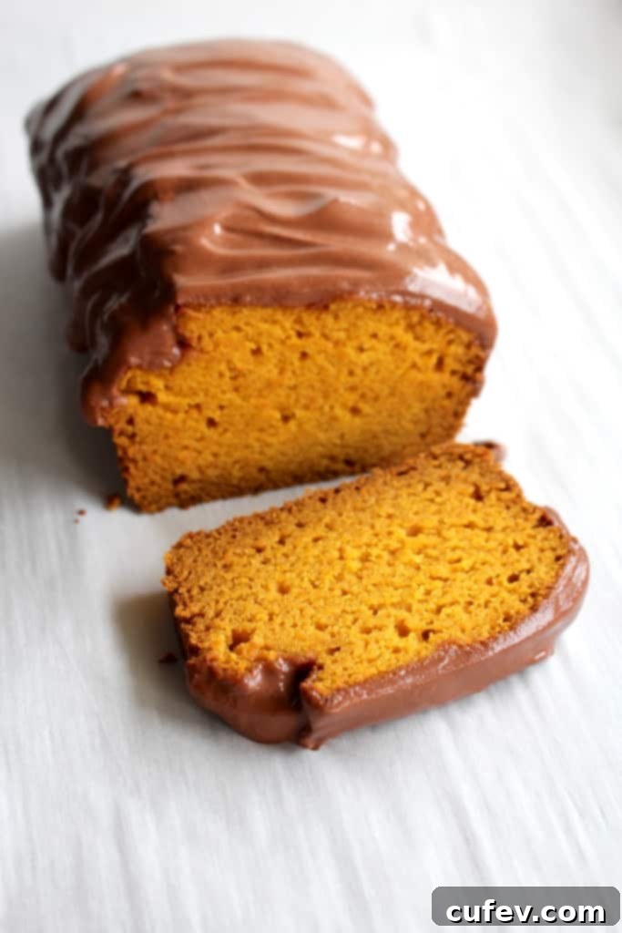 A festive carrot loaf cake, featuring pureed carrots and a smooth chocolate frosting, perfect for Easter dessert.