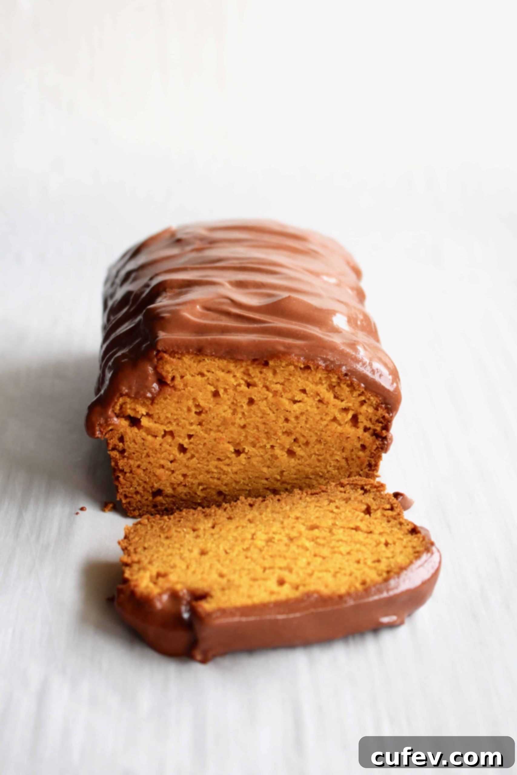 A loaf of Brazilian carrot cake with chocolate frosting.