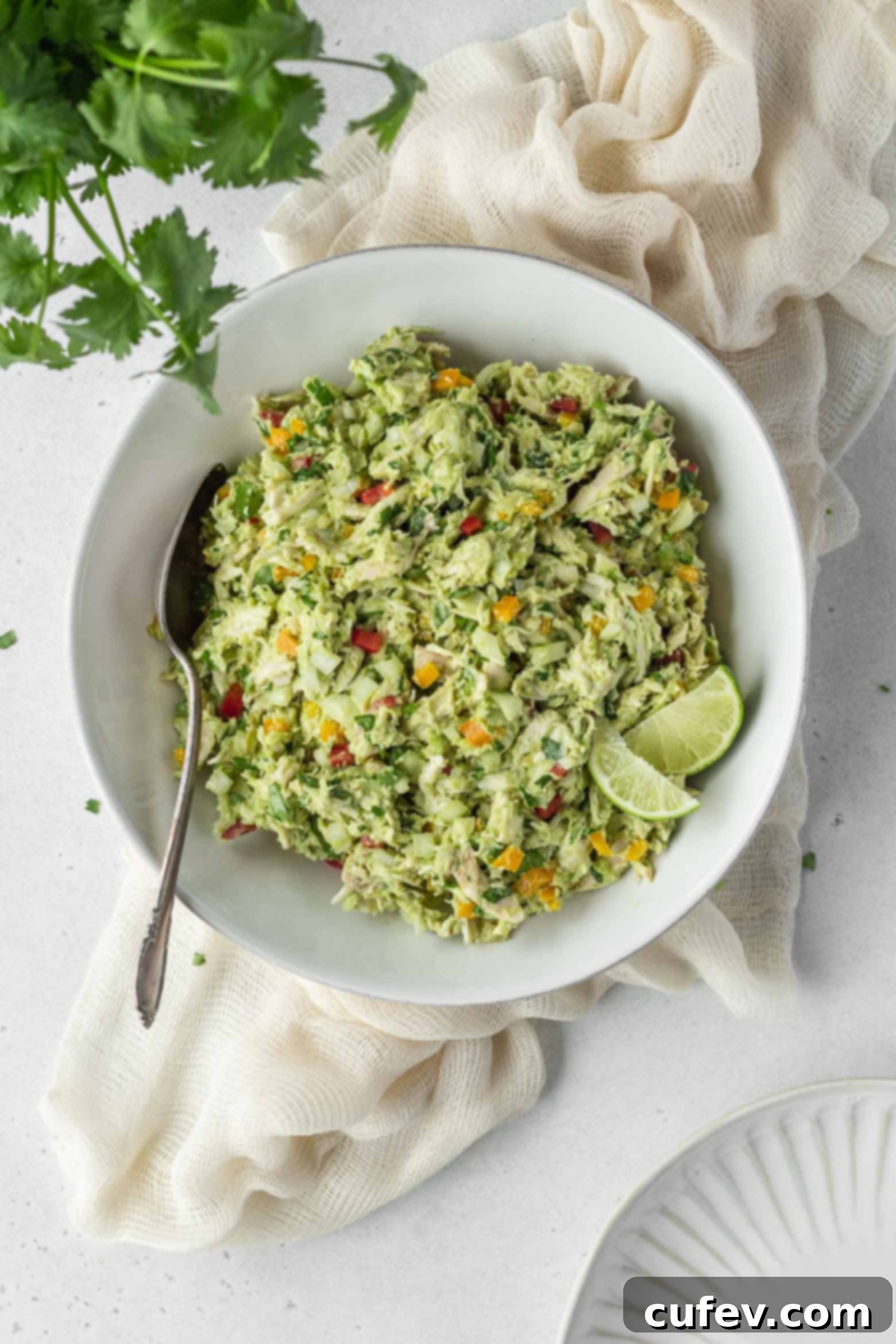 A bowl of chicken and avocado salad