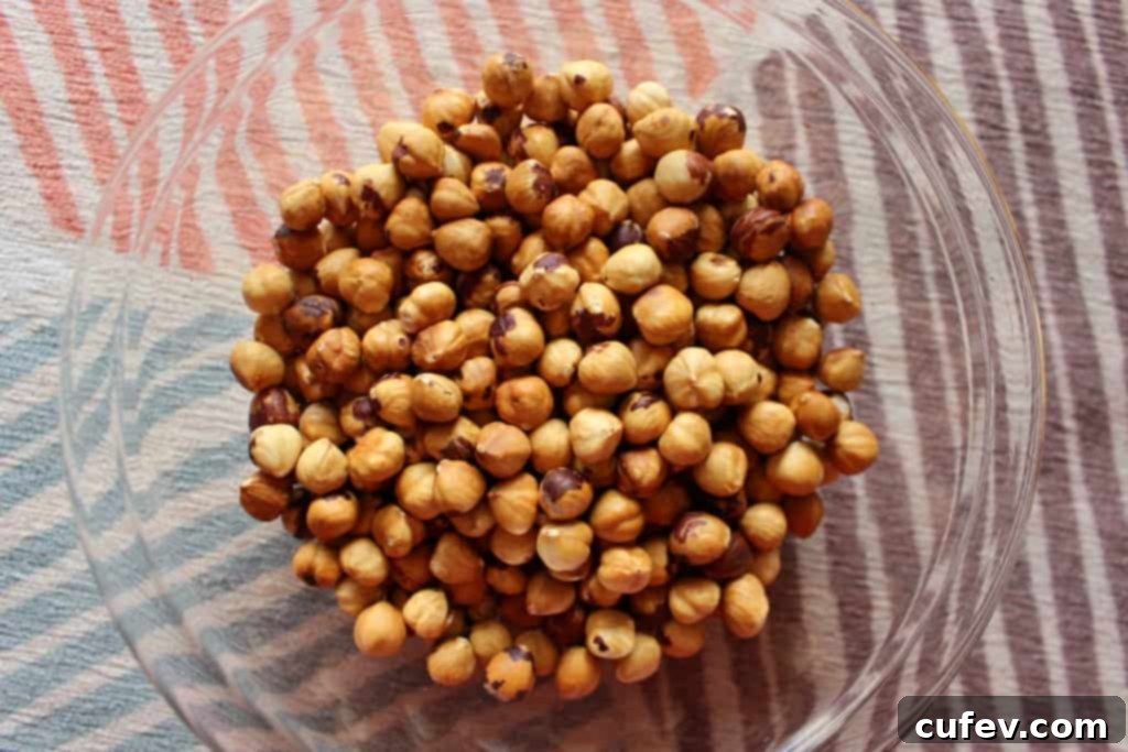 Peeled, perfectly roasted hazelnuts, golden brown and smooth, ready for seasoning or use.