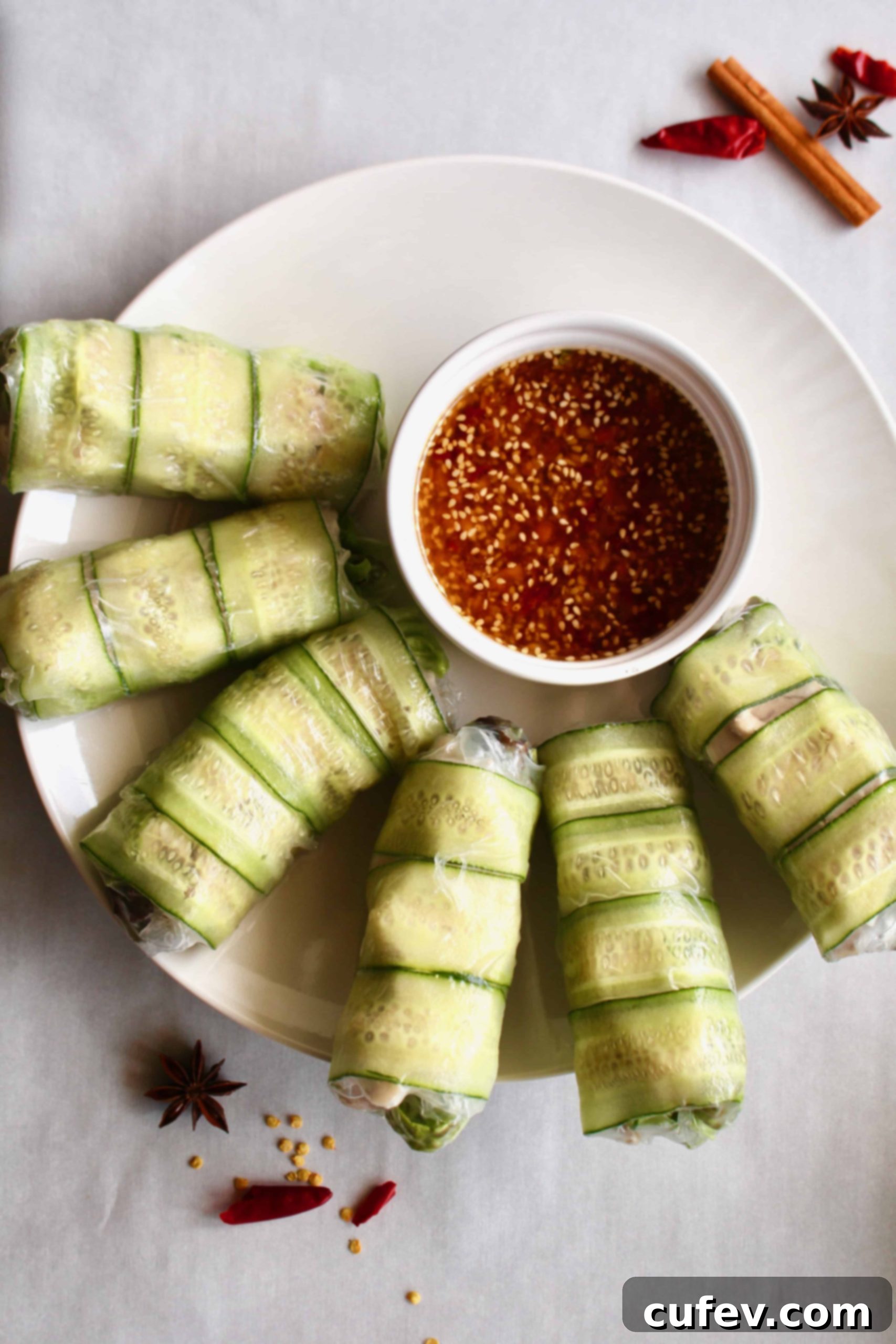 Need a fresh and light appetizer? These spicy chicken summer rolls are perfect! Moist and flavorful chicken is wrapped in rice paper with lettuce and cucumber, served with a spicy Sichuan dipping sauce! #summerrolls #springrolls #ricepaper #chicken #chickenthigh #chinese #sichuan #spicy #healthy #lettucewraps #appetizer #fresh #light #partyfood #asian