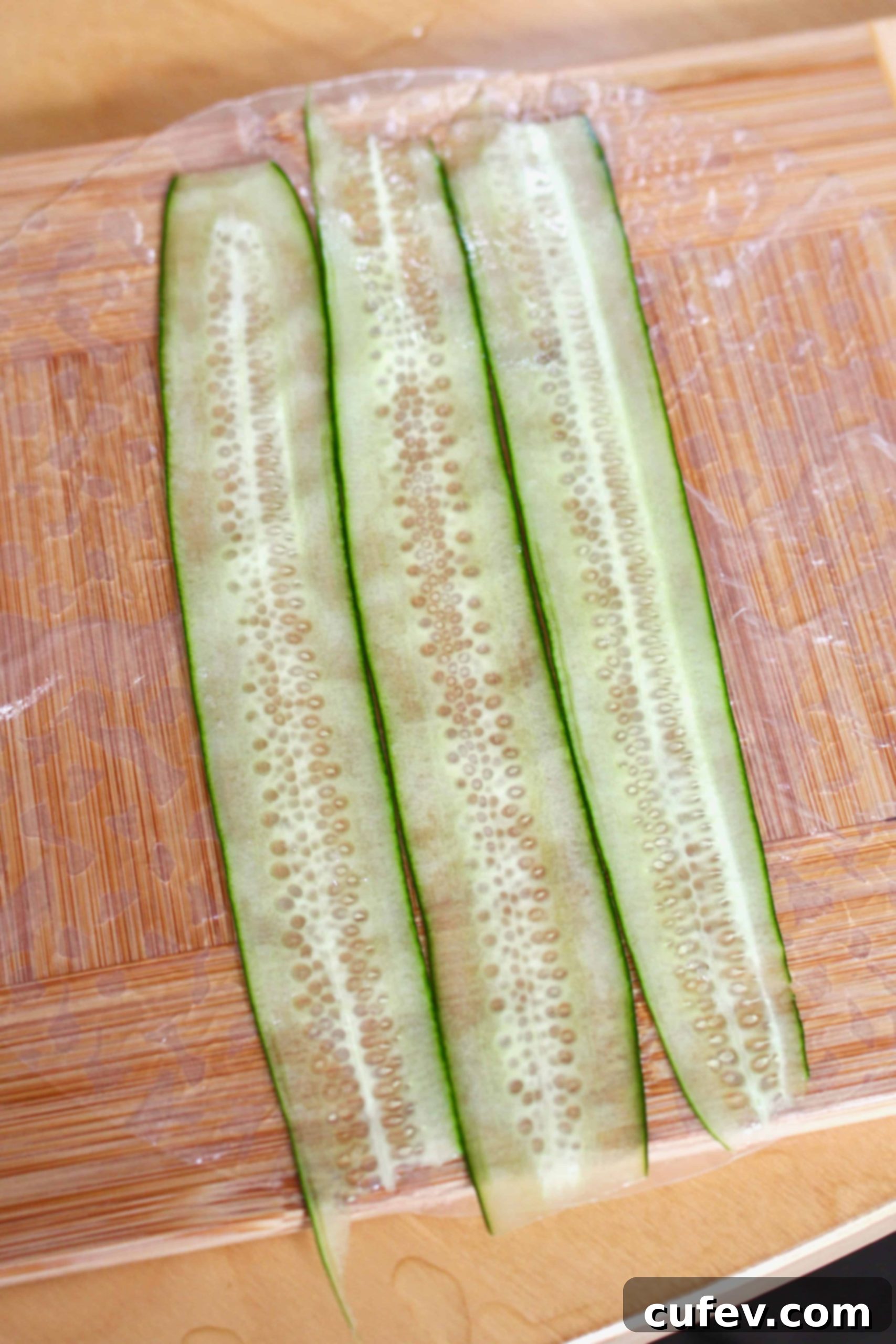 Sliced cucumbers laid on rice paper.