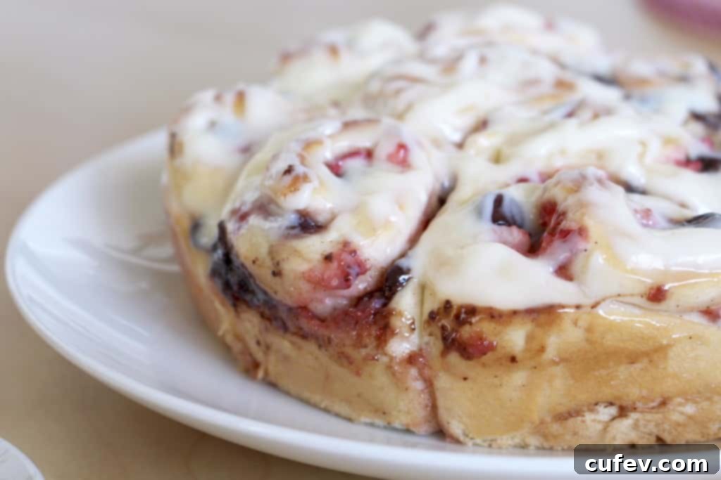 An enticing stack of strawberry chocolate rolls, ready to be enjoyed, showcasing their rich filling and frosting.