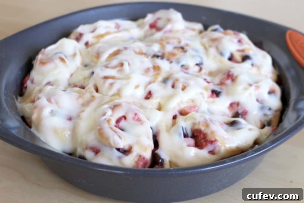 Golden brown, freshly baked strawberry chocolate rolls straight from the oven, fragrant and warm.