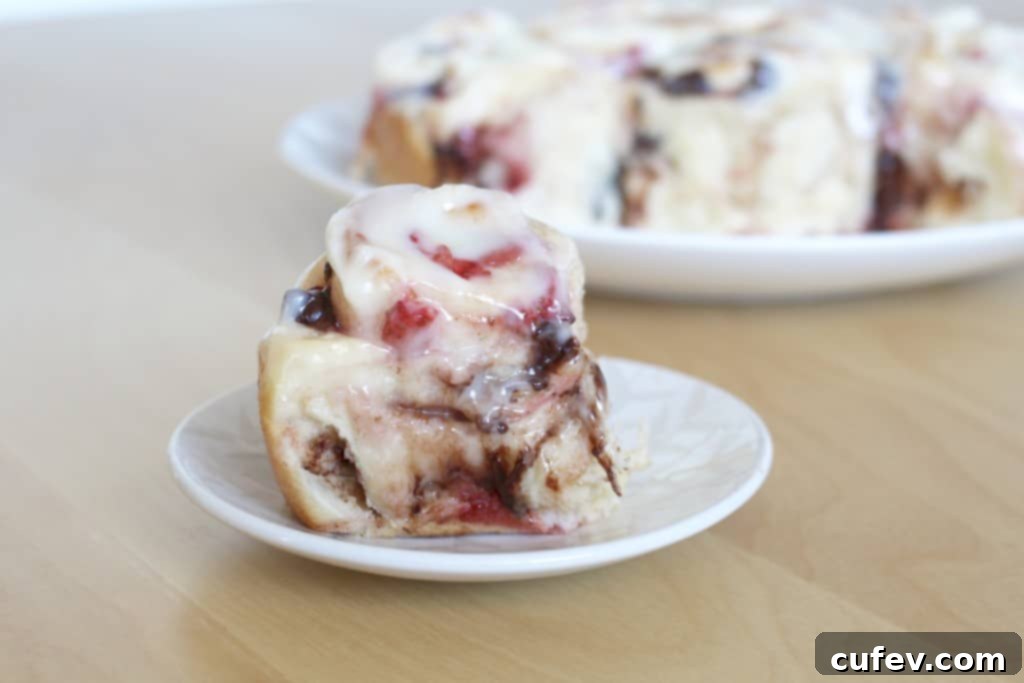 Warm strawberry chocolate rolls generously topped with a creamy, smooth cream cheese frosting.