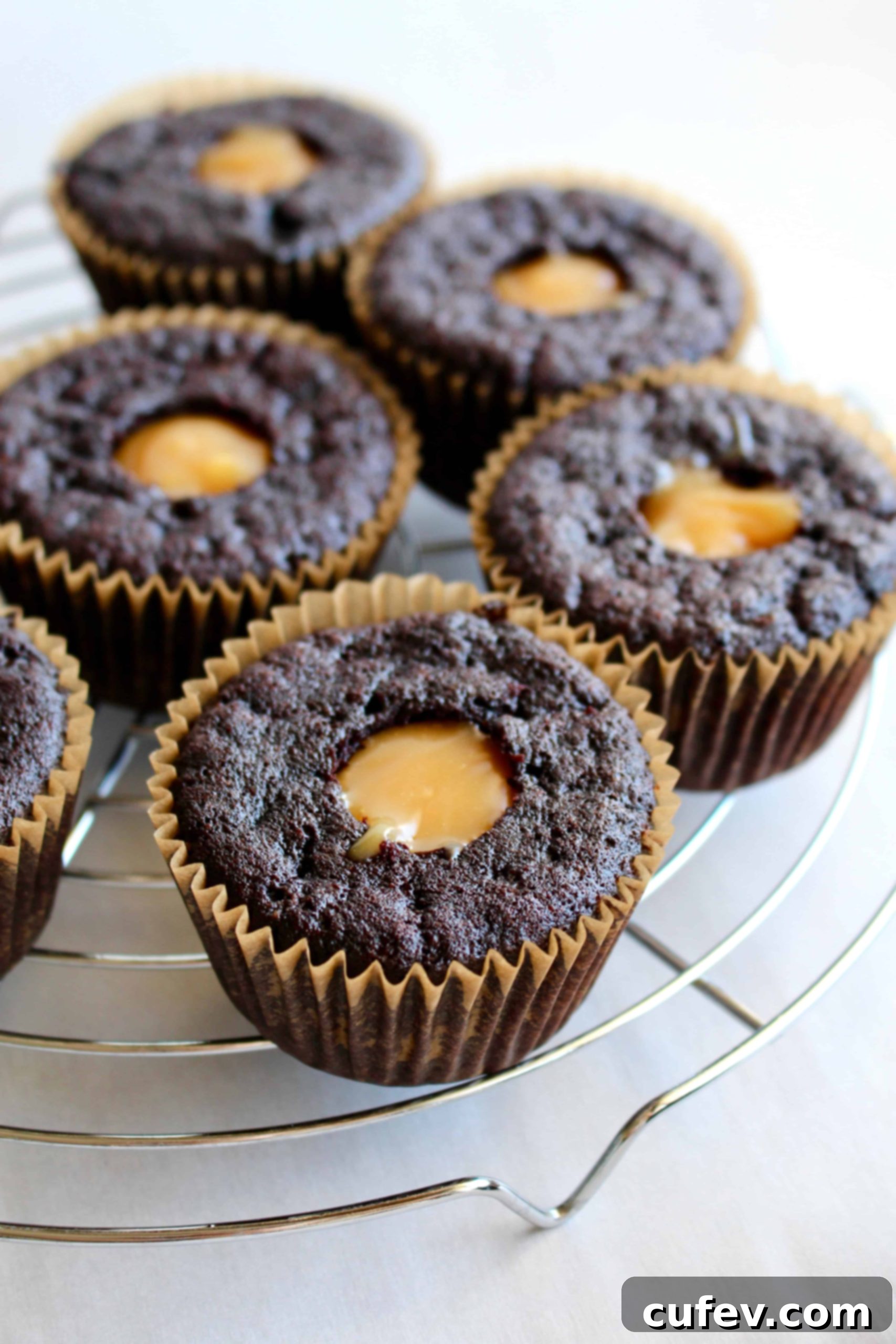 Vegan chocolate cupcakes, cored and filled with luscious vegan caramel sauce, ready for buttercream.