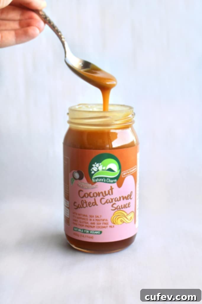 Nature's Charm coconut salted caramel sauce, a luscious vegan caramel perfect for filling and frosting these dairy-free chocolate cupcakes.