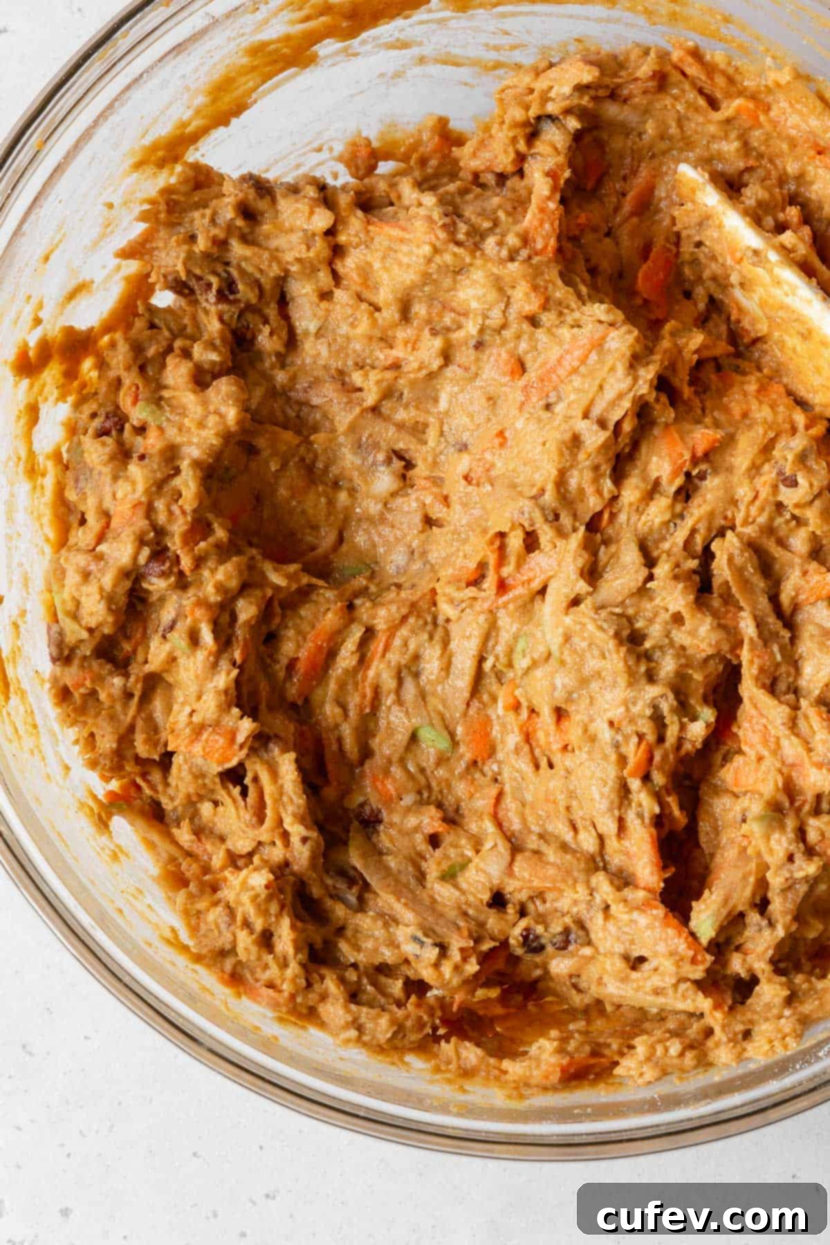 Process shot - healthy morning glory pumpkin muffin batter in a bowl after combining.