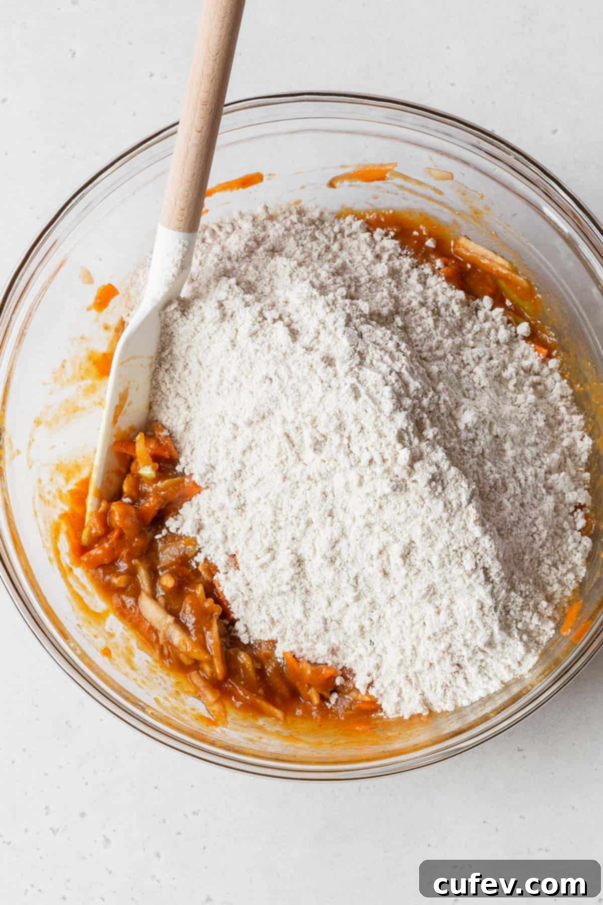 Process shot - dry ingredients added to bowl with wet ingredients.