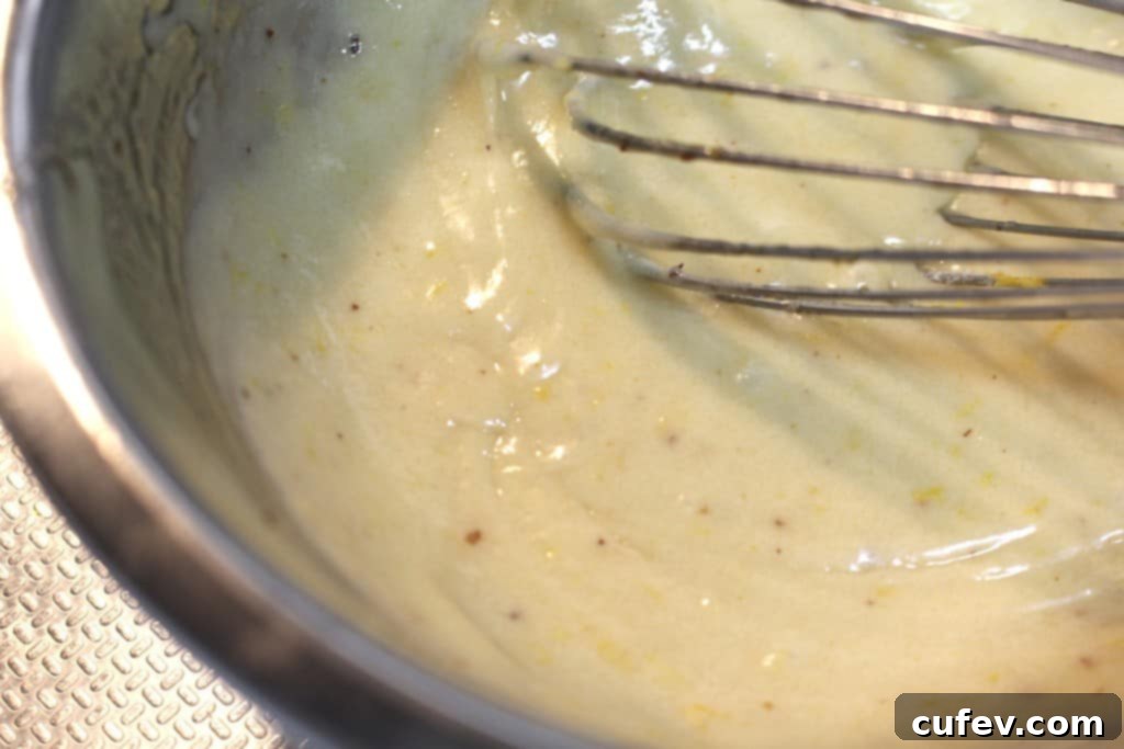 Financier batter after adding browned butter, whisked until smooth and fully combined.